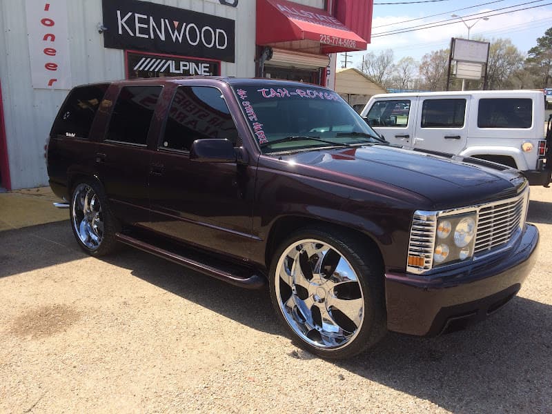 Dark purple SUV with chrome wheels parked in front of storefront at 360 Customs in Baton Rouge, Louisiana