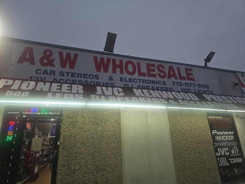 Storefront with a red and white sign and neon OPEN sign at A&W WHOLESALE in Houston, Texas