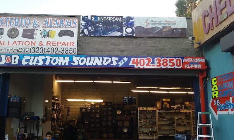 Open storefront bay with speaker boxes stacked inside at J&b Customs sounds in Los Angeles, California