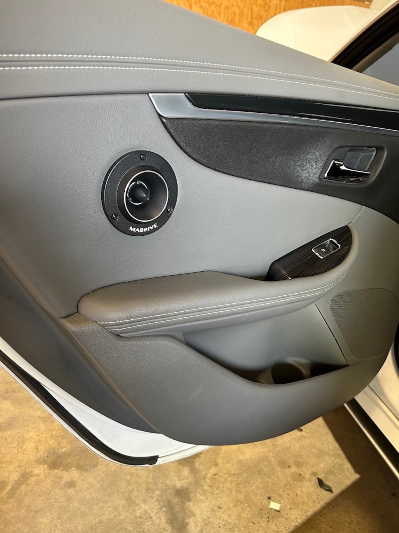 Car door panel with round Massive tweeter in gray leather at Bluegrass Beats in Bowling Green, Kentucky