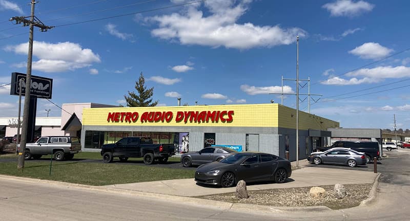 Storefront with yellow facade and red sign at Metro Audio Dynamics in Omaha, Nebraska