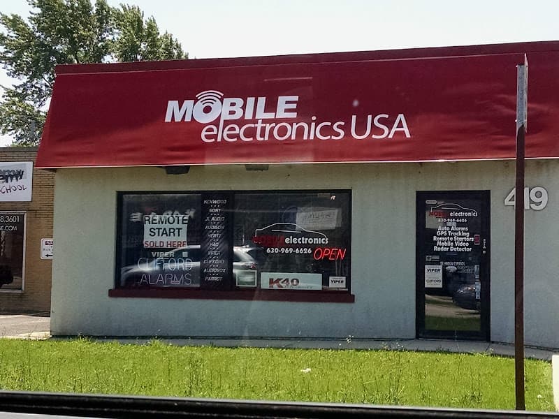 Storefront with red awning and window signs at Mobile Electronics USA, Inc. in Downers Grove, Illinois