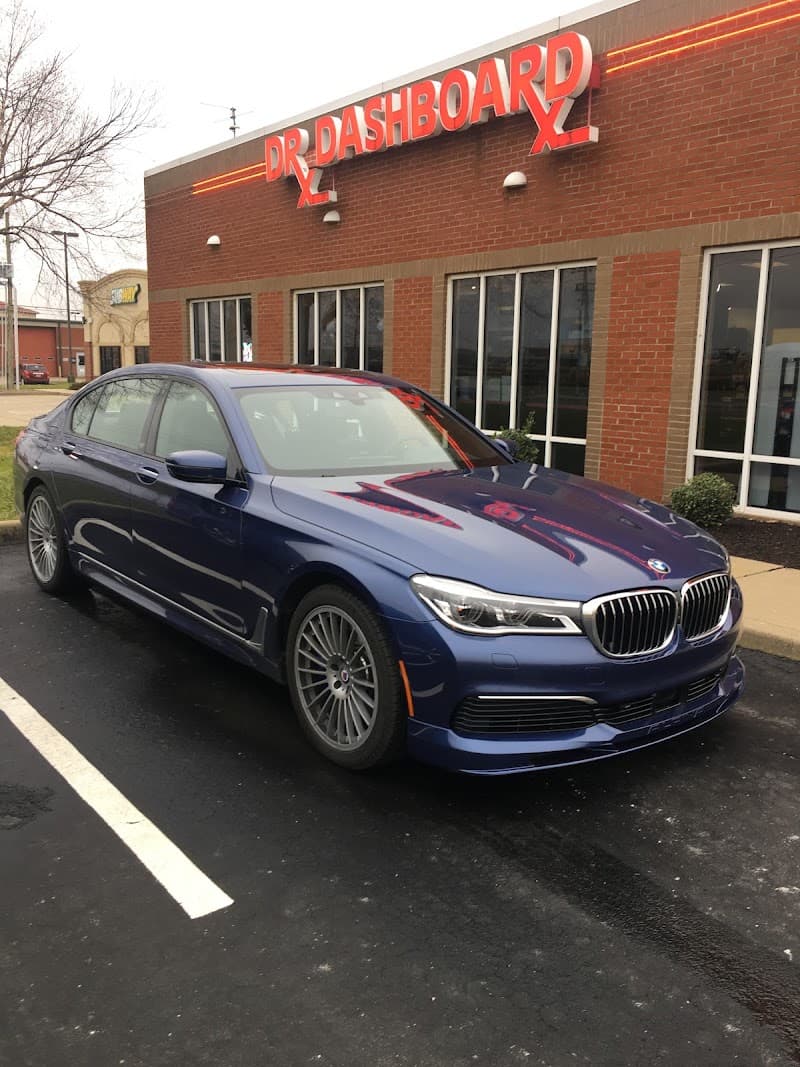 Blue BMW sedan parked in front of brick storefront at Dr Dashboard in Evansville, Indiana