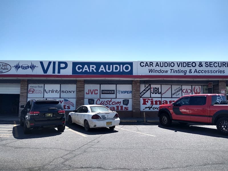Strip mall storefront with signs and brand logos at VIP Car Audio in Albuquerque, New Mexico