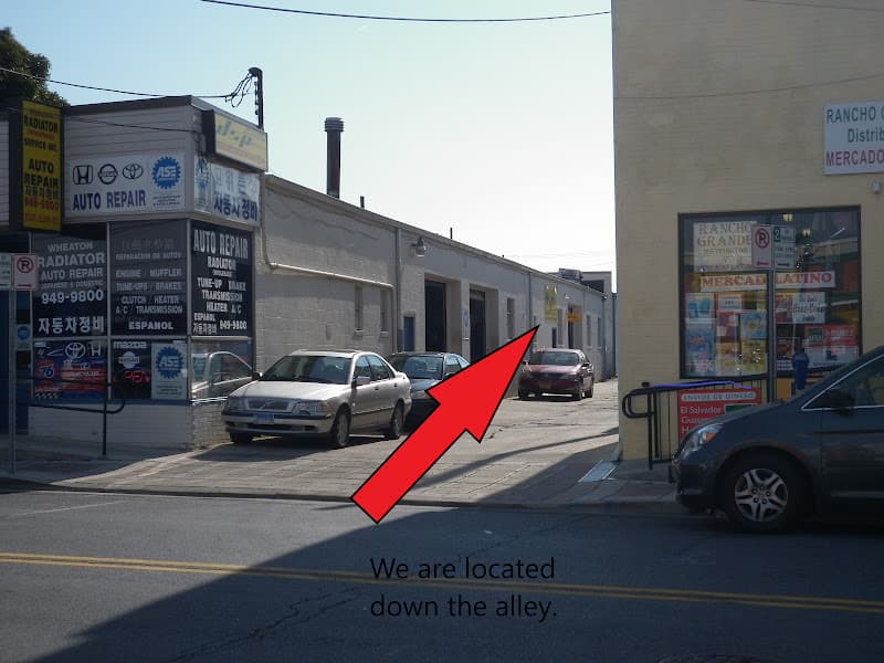 Street view of a red arrow and caption pointing down an alley at DSP Audio & Video in Silver Spring, Maryland