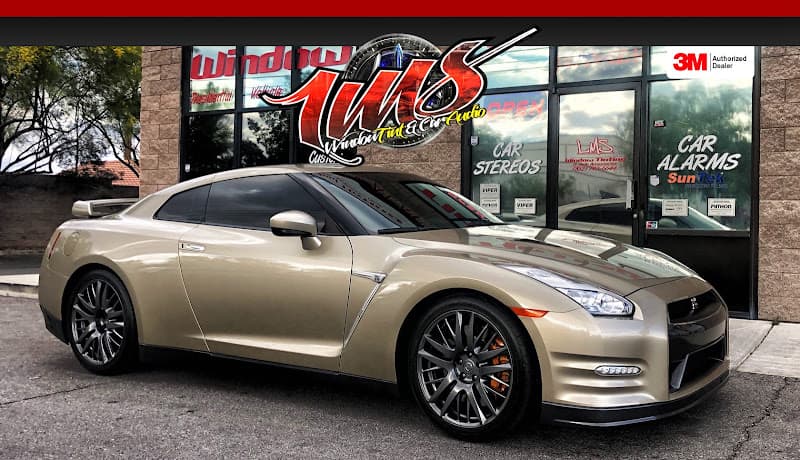 Gold coupe parked outside shop with car stereo signs at LMS Window Tint - 3M Authorized Dealer in North Las Vegas, Nevada