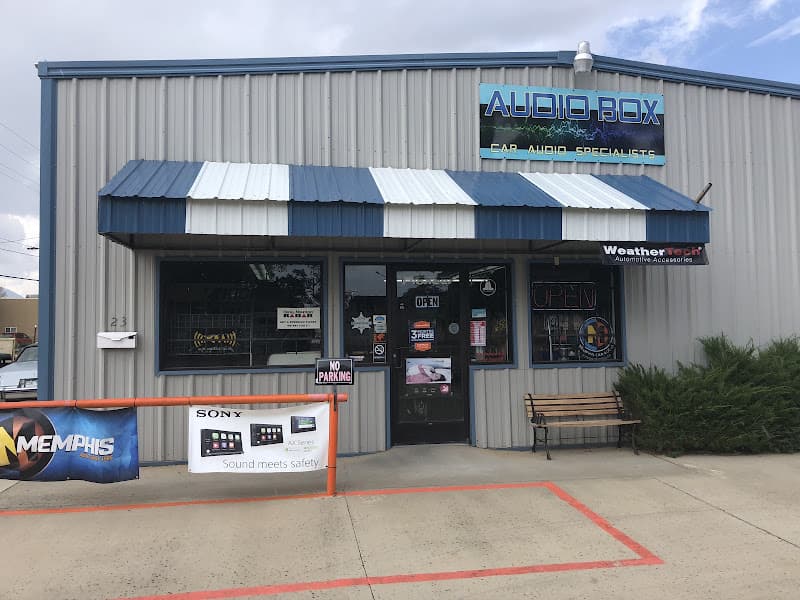 Storefront with a blue striped awning and a car audio sign at Audio Box in Cortez, Colorado