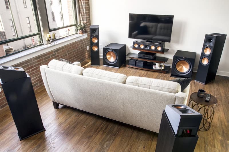 Home theater room with tower speakers, subwoofers and a sofa at AUDIO SYSTEM in Houston, Texas