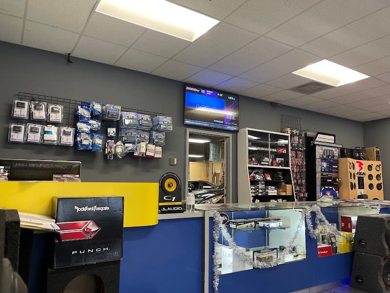 Retail counter with Rockford Fosgate box and products on wall at The Audio Connection in Columbia, Maryland