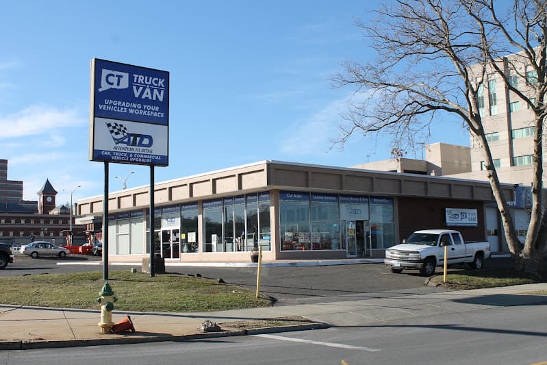 Tall blue sign and storefront with a white pickup parked outside at Attention To Detail in Middletown, Connecticut
