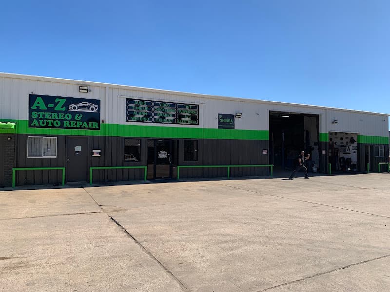 Metal shop building with green trim and a sign at AZ Stereo & Auto Repair in Houston, Texas