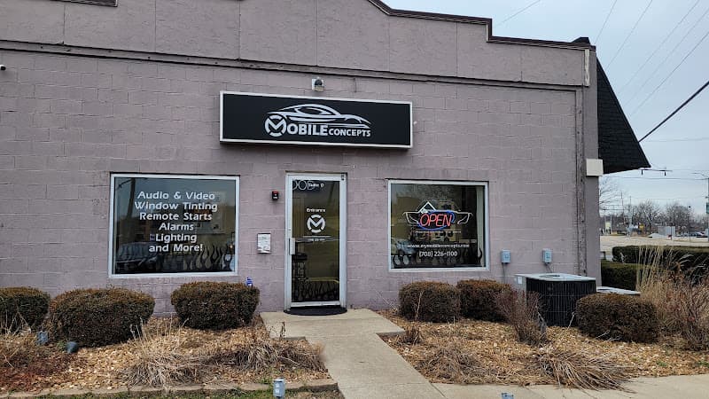 Storefront with window signs for audio, tinting and remote starts at Mobile Concepts in Mokena, Illinois