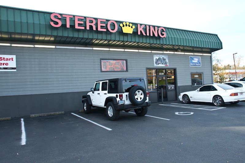 Storefront with green awning and parked white SUV at Stereo King in Portland, Oregon
