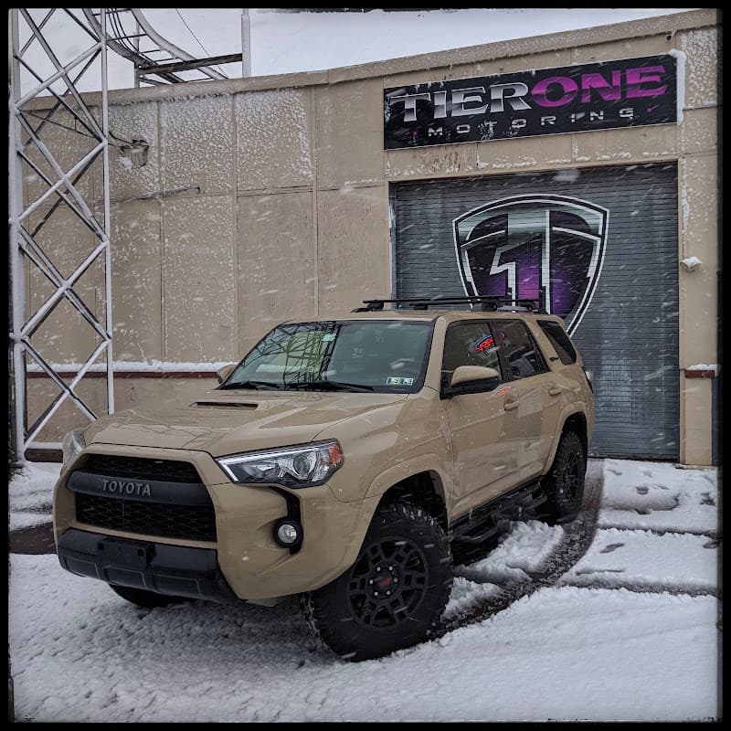 Tan Toyota SUV parked in snow outside shop at Ride Revolution/Tier One Motoring in Pottstown, Pennsylvania