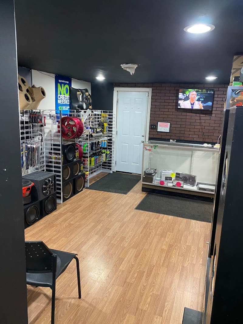 Showroom with glass display case and blue No Credit Needed sign at OC Car Audio in Wilmington, Delaware