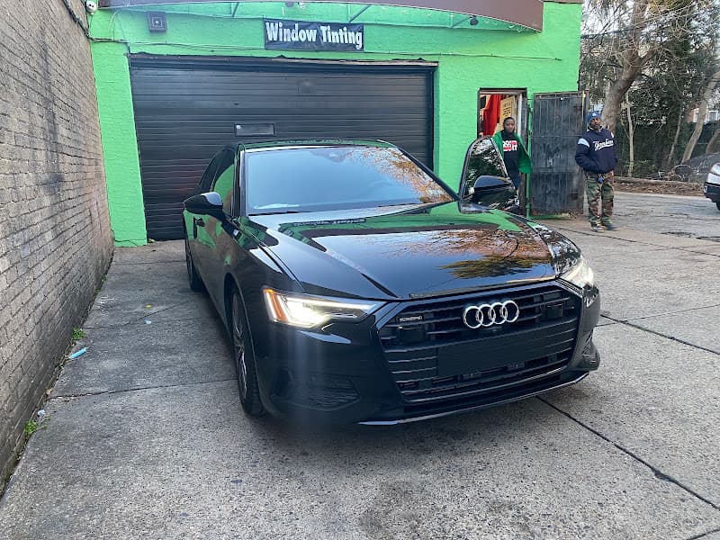 Black Audi sedan parked in front of a Window Tinting building at Auto Sound & Security in Philadelphia, Pennsylvania