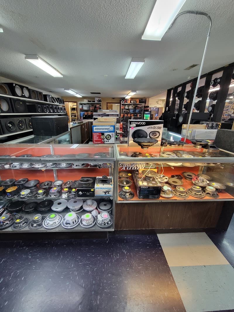 Glass display cases of speakers and car audio parts in showroom at Audio Kingdom Inc in Paducah, Kentucky
