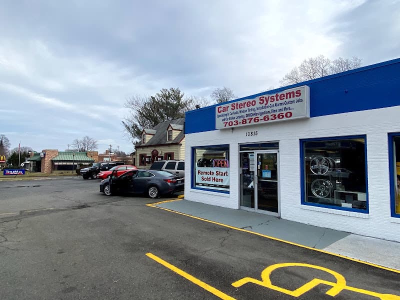 Storefront with blue trim, open sign and cars parked out front at Car Stereo Systems in Fairfax, Virginia