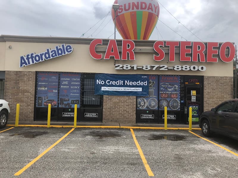 Storefront with red Car Stereo sign and a No Credit Needed banner at Affordable Car Stereo in Houston, Texas