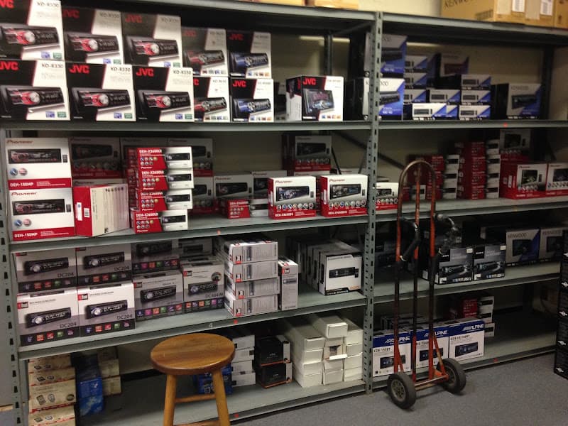 Shelves of boxed car stereos from JVC, Pioneer and Kenwood at Moon Car Stereo in Houston, Texas