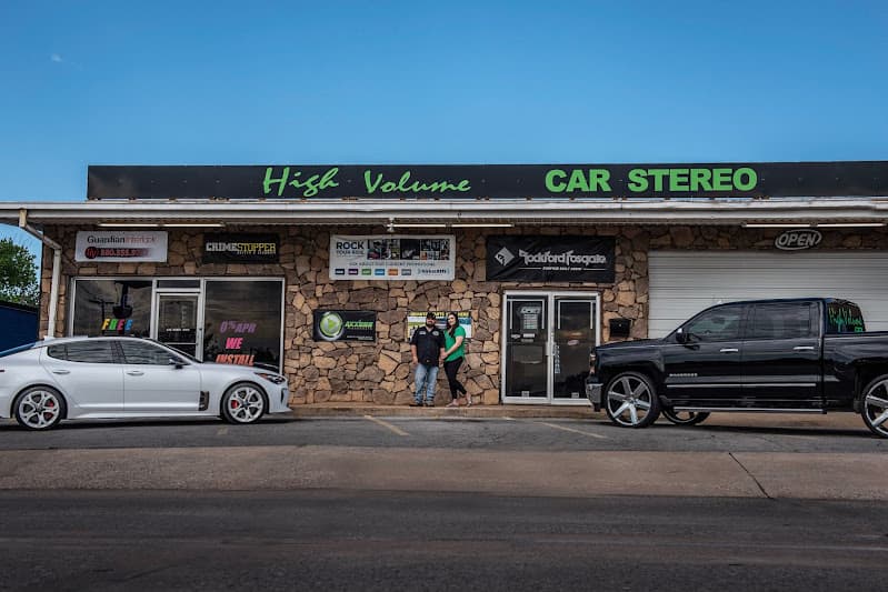 Stone storefront with white car and black pickup out front at High Volume Car Stereo in Lawton, Oklahoma
