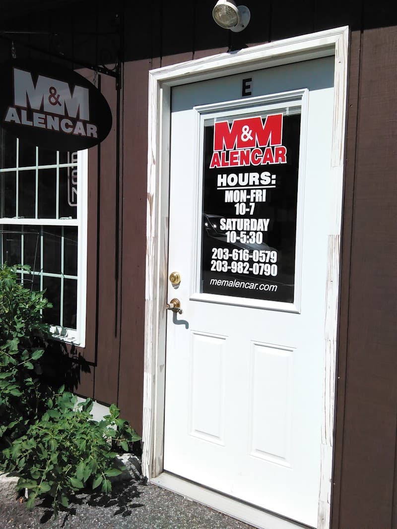 White entry door with hours decal at M&M Alencar Sound's Installation in Brookfield, Connecticut