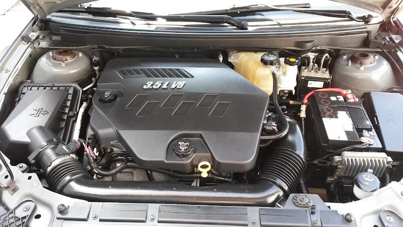 Engine bay of a car with 3.5L V6 engine cover at Porchia's Audio in Wichita, Kansas