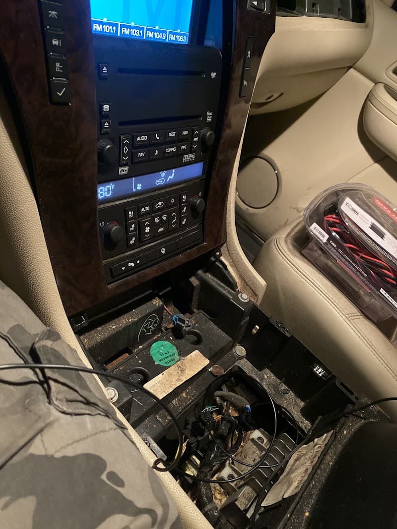 Center console with wood trim, a head unit and exposed wiring at Sounds by Tony in East Chicago, Indiana