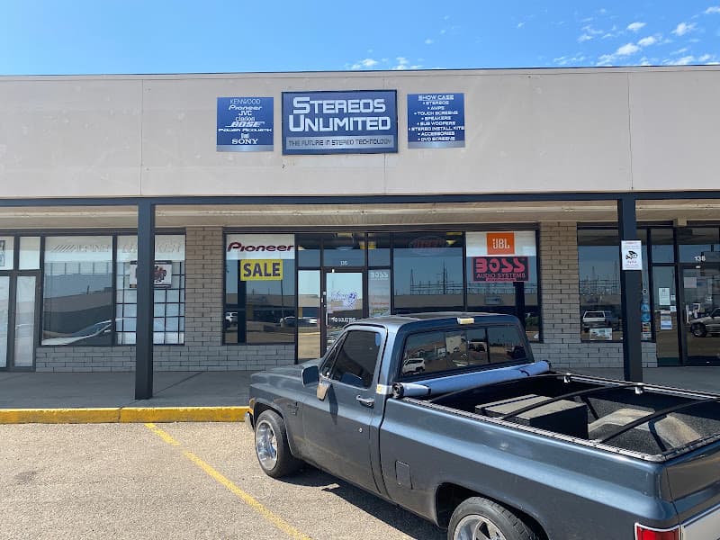 Storefront with blue sign and gray pickup truck parked outside at Stereos Unlimited in Amarillo, Texas